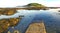 Bright evening sunshine, still, calm waters, rock pools and reef, in Looe Bay, Cornwall UK