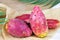 Bright exotic pink prickly pear cactus fruit or opuntia on light background.
