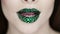 Bright eye makeup and green lips in rhinestones.