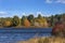 Bright fall foliage along shoreline of lake, Mansfield Hollow, C