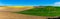 Bright farmland panorama. Colza field, cultivated area concept