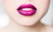 Bright female lips lipstick purple pink.