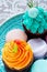 Bright, festive cupcake and macaroons