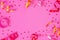 Bright festive pink background with streamers and hearts confetti