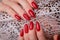 Bright festive red manicure on female hands. Nails design