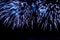 Bright fireworks scattering of sparks of blue color.