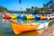 Bright fishing boats on the river bank