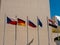 Bright flags of different states on the background of the building. The flags of the Czech Republic, Germany, Russia, the European