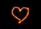 Bright flame burn heart symbol on black background in the dark, Valentine`s day or romantic concept background, copy