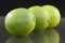 Bright fresh green limes on dark background