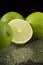 Bright fresh green limes on dark background