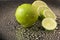 Bright fresh green limes on dark background