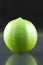 Bright fresh green limes on dark background