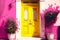 bright front door of house in yellow pink tones
