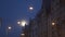 Bright full moon visible in the city streets using tele photo lens with city lights in the foreground and Riga typical