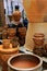 Bright glazes on clay planters arranged on wood tables