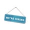 Bright glossy We are hiring sign hanging on the rope for shop door on white