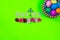 Bright green background with cross, Easter eggs and flowers with the words Easter with copy space