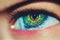 Bright green female human eye with yellowish pupil