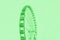 Bright green ferris wheel on a mint color background