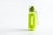 Bright green fitness sport bottle with dispenser and water and fresh apple on isolated white background. Healthcare and healthy