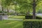 Bright green fresh lawn and trees bring natural beauty to residential homes area