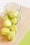 Bright green macaroons in glass jar