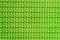 Bright green repeating patterned background. Abstract.