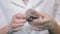 Bright grey ruby crystal ore in hands with gloves. Crystallization is the natural or artificial process by which a solid