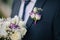 Bright groom boutonniere with bouquet