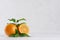 Bright group oranges with fresh green leaf and piece on soft light white modern interior.