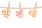 Bright hearts hanging on rope on wooden