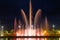 Bright high jets of singing and dancing fountains in the night sky on the embankment of the city of Batumi.