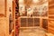 Bright home wine cellar with wooden storage units with bottles.