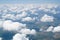Bright horizon from an airplane. Aerial view of beautiful small white clouds. Window seat view. Light background