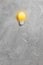 Bright idea illuminated light bulb on grey background. Creative inspiration, planning ideas concept. Flat lay, top view