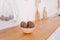 Bright interior of e kitchen is made of natural eco-components. Bamboo bowl with decorative balls on wooden countertop of the