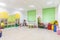 Bright Interior of a modern kindergarten in yellow and green colors. Panoramic view.