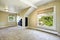 Bright ivory room with vaulted ceiling and built-in shelves. Empty house interior