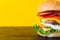 Bright juicy appetizing burgers with chops, cheese, marinated cu