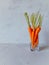 Bright and juicy carrots in a glass glass