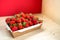 Bright juicy selected strawberries in a portioned cardboard box.
