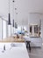 Bright kitchen contemporary style overlooking the living. White and wooden facade. Built-in appliances and designer hoods.