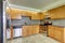 Bright kitchen room interior with light tones cabinets and steel appliances