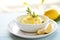 bright lemon gelato in a ceramic dish with a zest twist