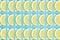 Bright lemon slice repeat pattern on a blue background. Flat lay summer concept