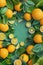 Bright lemon top view mockup. Lemon and green branches in layered paper cut style. Green background, vibrant citrus fruits, empty