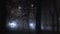 Bright light from headlamps of cars shines through the fog on a road at night, poor visibility due to haze