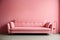 Bright light pink couch near color solid wall in empty living room