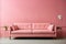 Bright light pink couch near color solid wall in empty living room